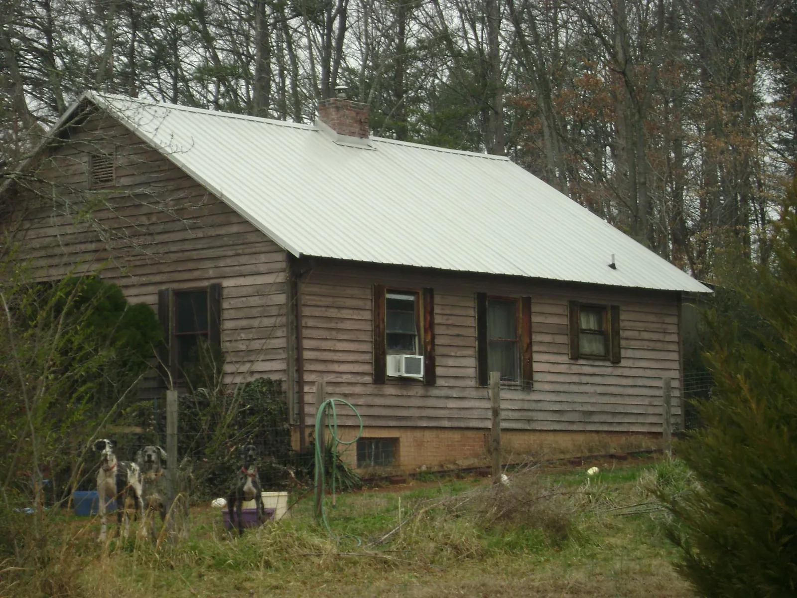 White metal roof on an old wood sided farmhouse, from a Metal Roof Installation job in Greensburg